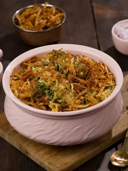 Here is an alternative styling for the same biryani dish, using a different bowl. We offer variations to clients so they can choose the aesthetic that best fits their brand, whether it's modern copper or rustic ceramic.
