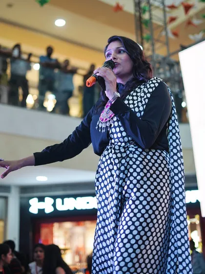 A powerful shot of me on stage at the Pacific Mall in Dehradun, hosting the Global Village festival. I am confident and command attention in any setting.