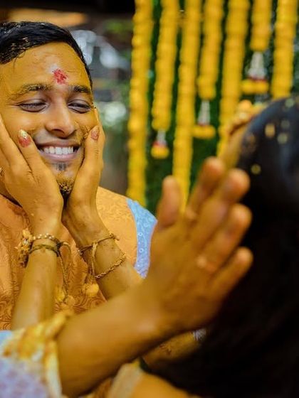 A sweet, candid moment of a bride applying turmeric to the groom's face. We capture the tender interactions that are part of the Haldi rituals.