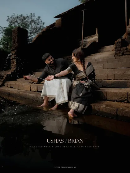 A dramatic and romantic portrait of a couple by a temple pond, capturing a moment of quiet intimacy for their pre-wedding session.