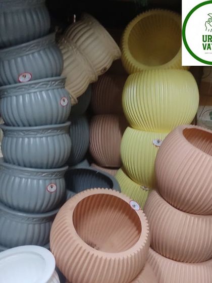 A collection of round, ribbed plastic pots in earthy tones.