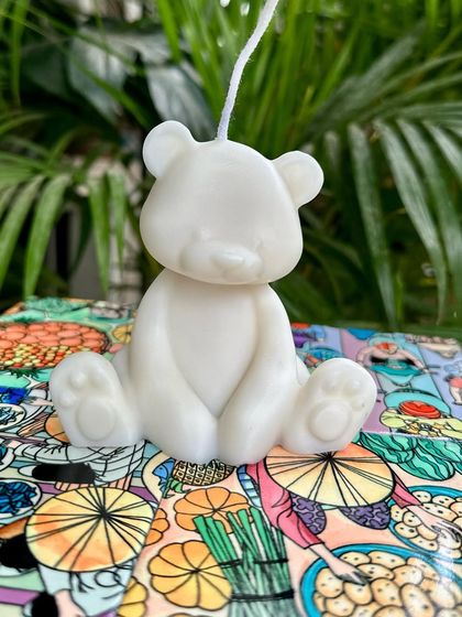 A simple and cute teddy bear soy candle. This is a popular choice for baby shower favors or as a small gift for a child's room.