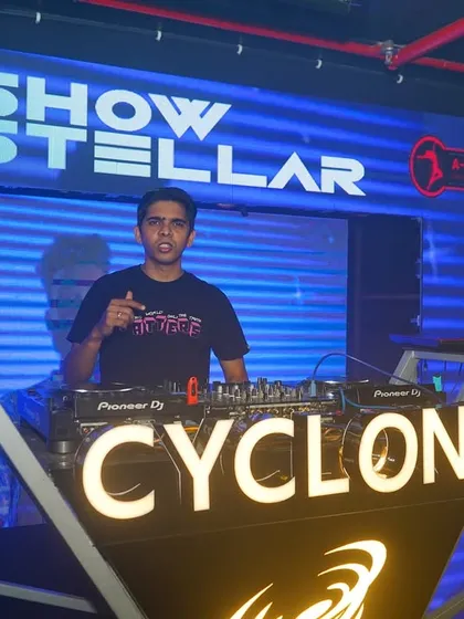 Posing at the Cyclone booth, where the VJ screen is an integral part of the setup.