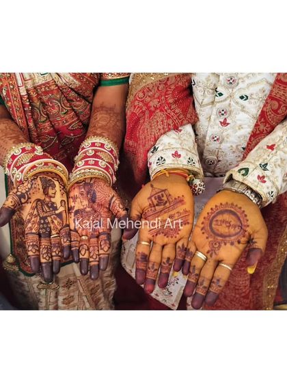 A beautiful shot of the bride and groom showcasing their mehndi. Her hands tell their story with portraits, while his features minimalist traditional symbols. This is what a complete couple's package looks like.