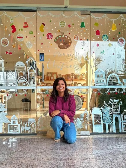 Welcome to my studio, my happy place. I decorated our glass doors for Christmas, and it shows how you can use any surface as a canvas. The studio is designed to be a bright, inspiring space for everyone who walks in.
