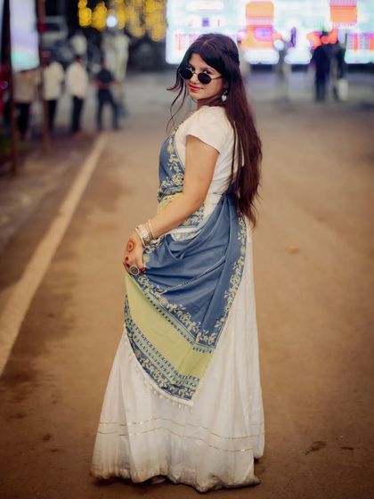 A stylish portrait from the same event. The way she holds her dupatta and looks back at the camera is full of attitude and grace.