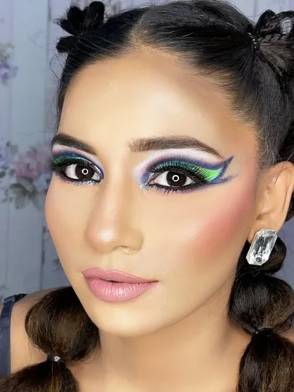 A direct, face-on view of the creative makeup, showing its symmetrical application and bold impact.