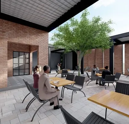 An open-air courtyard designed for a street-side cafe. We focused on creating a tranquil escape within the city, using natural elements like the central tree and combining exposed brick with modern steel structures to craft a space where people can connect and relax.