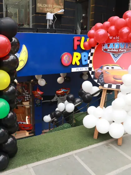 The entrance to a fantastic Cars-themed birthday bash. The custom welcome sign and balloon decorations promise a day full of high-speed fun.