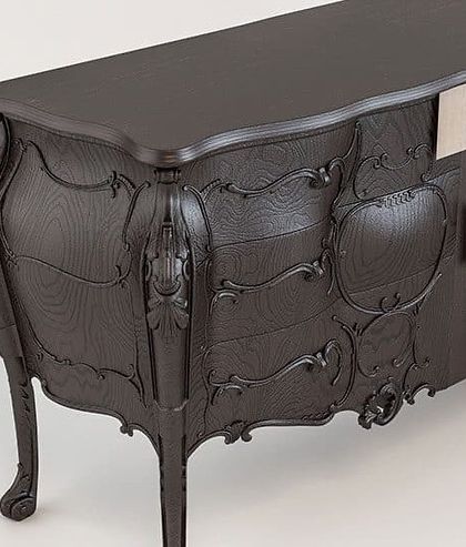 A close-up of the Abacus Sideboard, showing the intricate, hand-carved classical details that contrast with its modern, block-like structure.