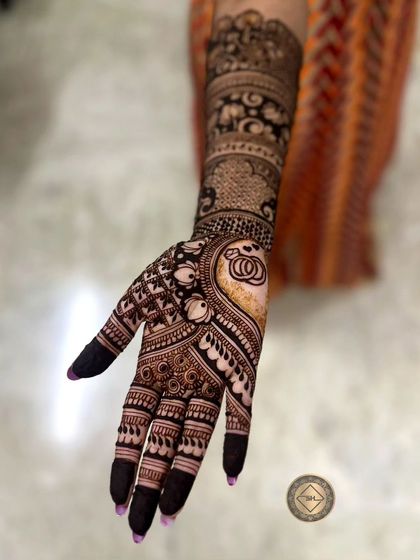 A side view of the engagement henna for Vachana, showing the detail on one arm. You can see the ring ceremony symbol and elephant motifs woven into the pattern on the forearm.