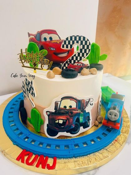 Ka-chow. This Lightning McQueen cake is ready to race, complete with a track and a friendly Thomas the Train making a guest appearance.