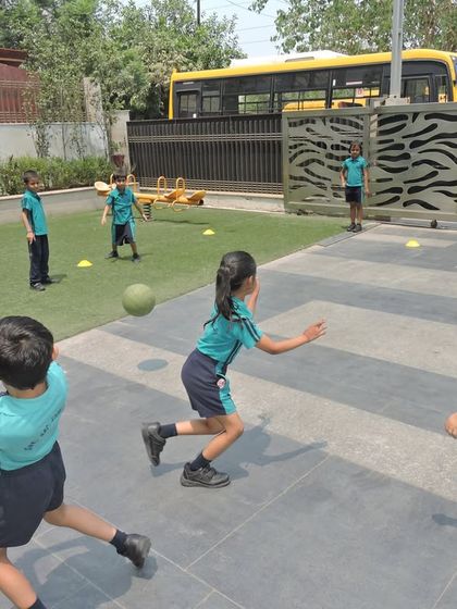 An action shot from an inter-house dodgeball game, where students learn about teamwork, quick reflexes, and friendly competition in our outdoor play area.