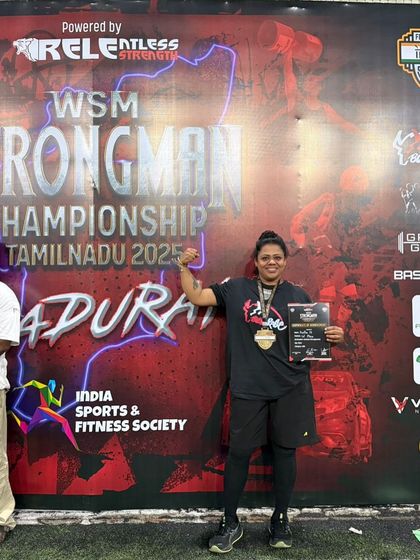 Holding my certificate and medal at the Strongman Championship. Every competition teaches me more about strength and resilience, lessons I pass on to all my clients.