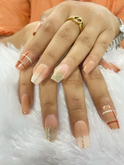 A beautiful set of custom press-on extensions. This design features a nude base with ombré, glitter, and plaid line work, showcasing the variety of art I can create for your own set.