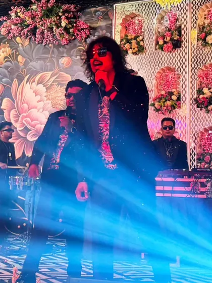 Me performing on stage with my live band. I often join in the performance to bring my personal energy to the event, ensuring it's a night to remember.