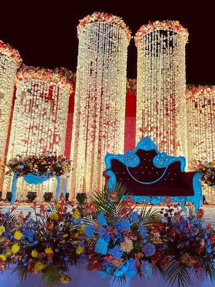 A different angle of the magnificent floral pillar stage, showing the deep red velvet sofa that adds a touch of royalty.
