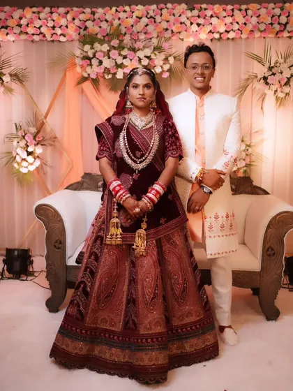 A full-length portrait of the bride and groom on their wedding stage, a complete picture of bridal elegance.