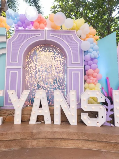 We can transform any space into a magical world. This large-scale "Under the Sea" theme features custom-built pastel arches, shimmering sequin backdrops, and marquee letters spelling out the birthday girl's name, Viyanshi.