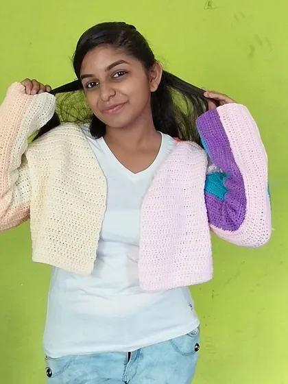 Showing off the fun, puffy sleeves of the pastel cardigan.