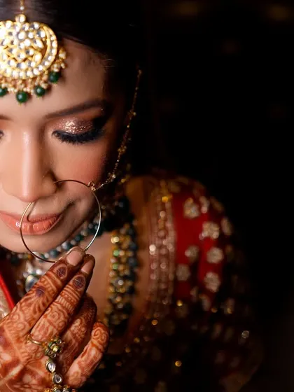 A bride's quiet moment of reflection before she walks down the aisle. I focus on capturing the delicate details, from the sparkle in her eyes to the intricate henna, telling a story of anticipation and beauty.