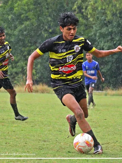 A player from my academy dribbles past a defender during a competitive Football Delhi B Division league match. You can see the intensity and skill required to compete, even in challenging rainy conditions.