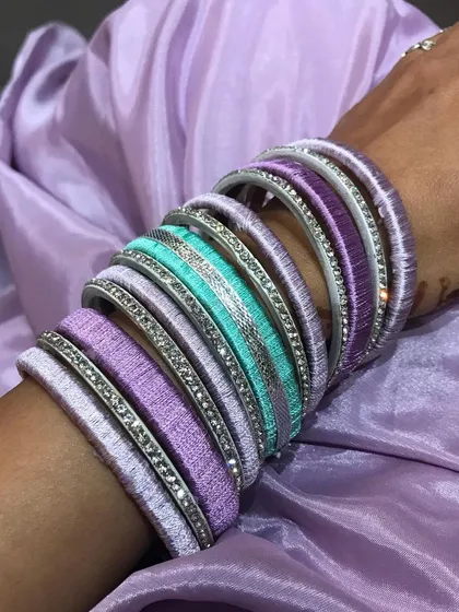 Here’s a look at a custom bangle set I created to perfectly match an outfit. I love working with silk thread to make these beautiful lavender, purple, and turquoise bangles that feel so special to wear.