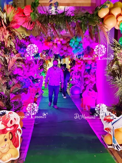 A guest's perspective walking through the vibrant, colorfully lit jungle entrance tunnel.