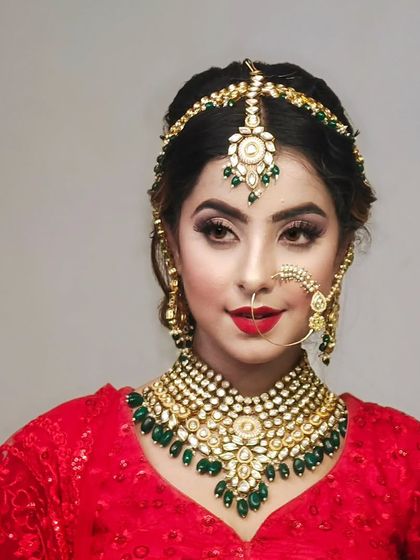 A full bridal set with a Kundan and emerald necklace, matha patti, and nath. This is a complete rental solution for your wedding day.