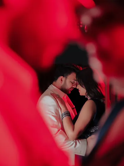 A passionate and moody shot using red gels and foreground blur. This technique creates a very intense and romantic image, perfect for couples who want something bold.