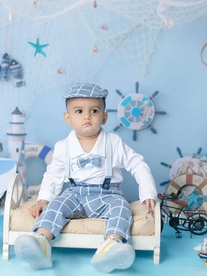 All aboard! This nautical sailor theme is a classic and adorable choice for a baby boy's photoshoot, complete with a little sailor suit and sea-themed props.