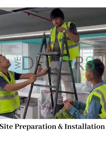 Our skilled installation team is the backbone of our work. Here they are on-site, carefully installing hanging greenery in a corporate office, bringing our design concepts to life with precision and care.