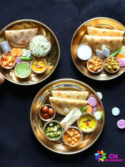 A beautiful collection of three North Indian thalis on a black background.