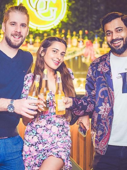 A group of friends toasting with beers.