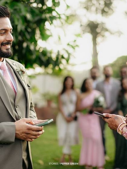 Ameera and Richard exchanging vows or sharing a reading at their outdoor ceremony. These personal touches make each wedding story unique.
