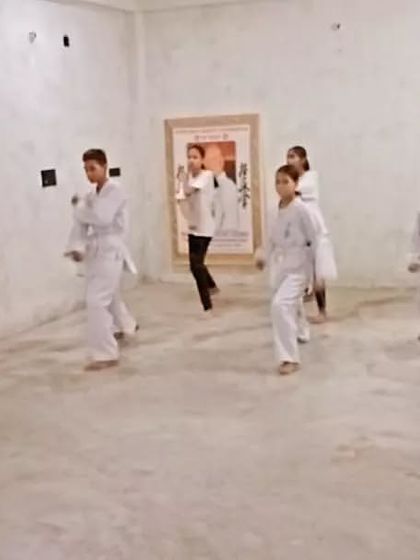 The class is practicing basic punches. The goal is to make every punch sharp and powerful.