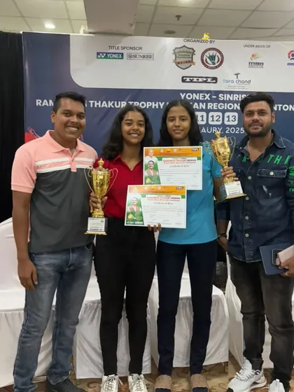 A candid shot of our U17 Girls Doubles runners-up, Riya and Nidhi, with their trophies and certificates.