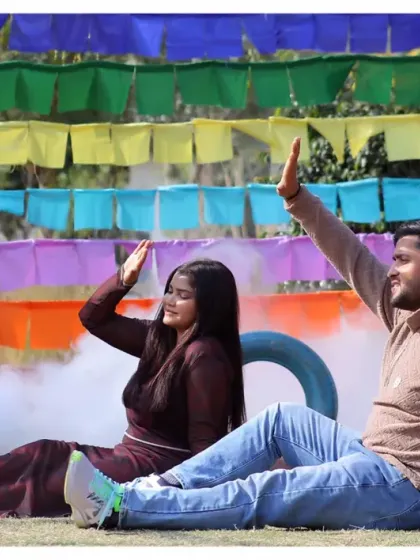 A playful moment from a pre-wedding shoot with colorful prayer flags and smoke effects. This kind of vibrant and dynamic shot is full of energy and fun.