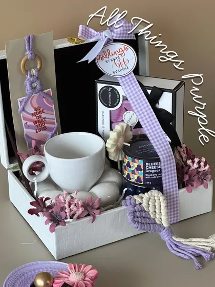For the sister who loves a specific color palette, this 'All Things Purple' hamper is a dream. It features a beautiful ceramic mug, blueberry cheesecake dessert jar, and other purple-themed goodies.