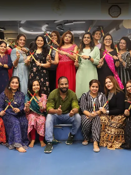 Our Navratri celebration, with everyone dressed in traditional attire and holding dandiya sticks. The spirit of community is strong here.