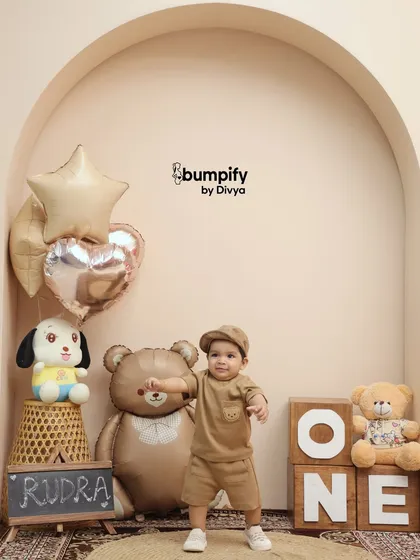 This little guy is celebrating his first birthday in our 'Teddy Bear World' studio setup. The neutral tones and cute props make for an adorable and timeless portrait.