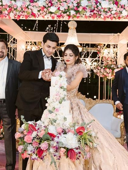 The cake cutting is such a special moment. I love ensuring the decor around it is just as sweet, with the floral stage creating a beautiful frame for the couple's celebration.