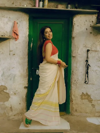 A series from an outdoor shoot, using a rustic green door as a complementary background for the red and white saree. These images show how I use color theory and natural environments to compose a shot.