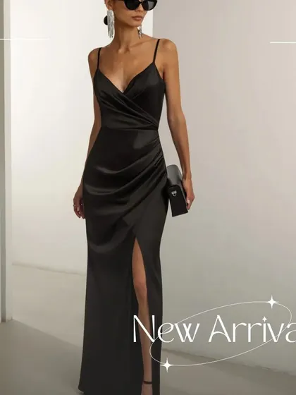 The Gianna dress is one of my signature styles, crafted from luxurious black satin. It features a classic V-neck, delicate spaghetti straps, and artful ruching that drapes across the body, finished with a thigh-high slit.