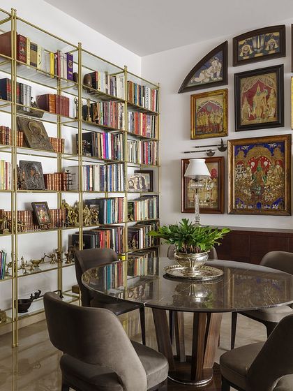 The entrance area of the Courtyard Home, where a focal wall is adorned with exquisite old Vaishnavite Tanjore paintings. These are juxtaposed with brass Pharaonic mirrors and Shia Alams, creating an immediate sense of the home's multicultural soul.
