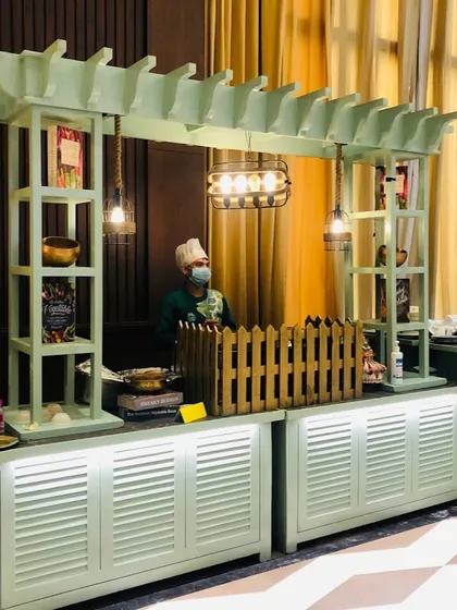 Our live food stations are a highlight at any event. This custom-designed mint green counter adds a unique and modern touch to a corporate gathering, where our chef is ready to serve fresh, delicious food to your guests.