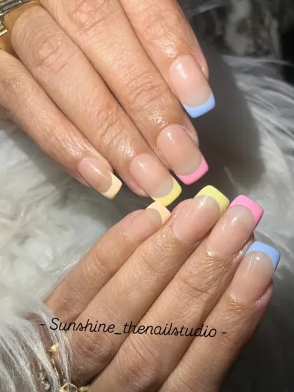 A close-up of the pastel rainbow French manicure.