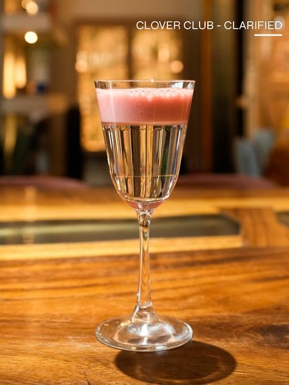 A clarified Clover Club, showcasing our innovative techniques. The clear base and vibrant pink foam top make for a visually striking and delicious gin cocktail.