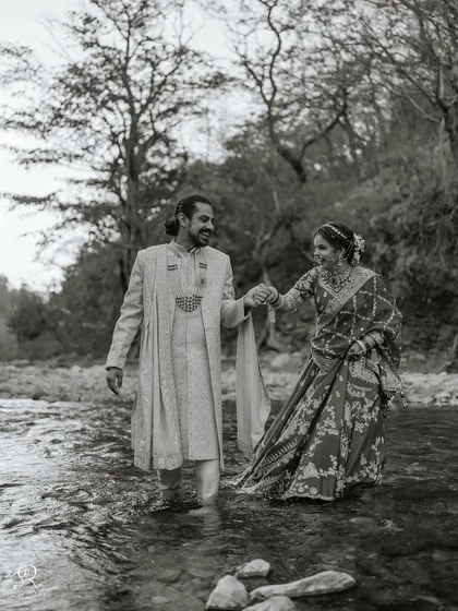 Who says you can't be adventurous on your wedding day? Nikita and Sachin were brave enough to step into the ice-cold Ganga river in Rishikesh for their portraits. This black and white photograph captures their playful spirit and the beautiful madness of their love story. These are the unique, candid wedding photos I love creating.