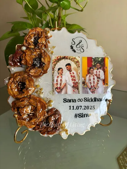 This geode-style plate shows how multiple photos can be incorporated into one piece. It features two wedding photos alongside preserved flowers and the couple's custom wedding hashtag.